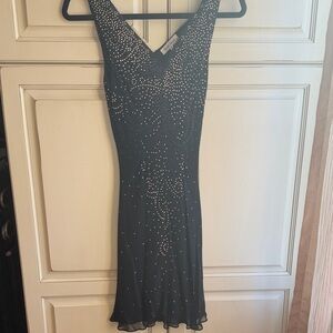 French Chic Black Sleeveless Dress with Studded Detail. This will fit a size 0.